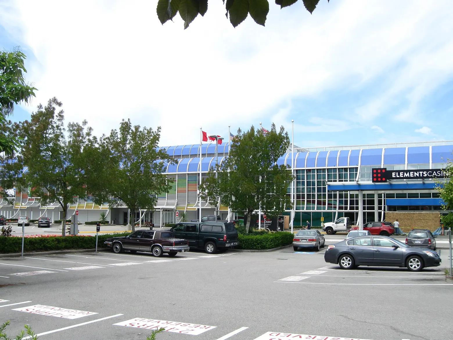 The Elements Casino Surrey building with its curved roof, across the parking lot