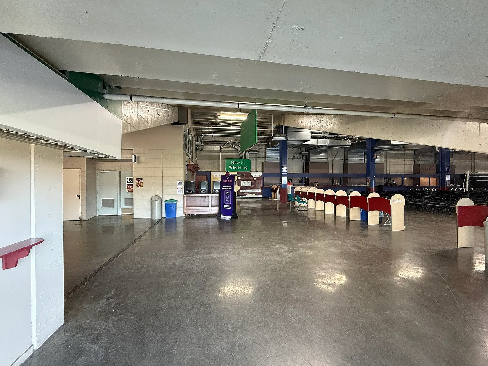 Inside the Hastings grandstand: a long hall with betting counters