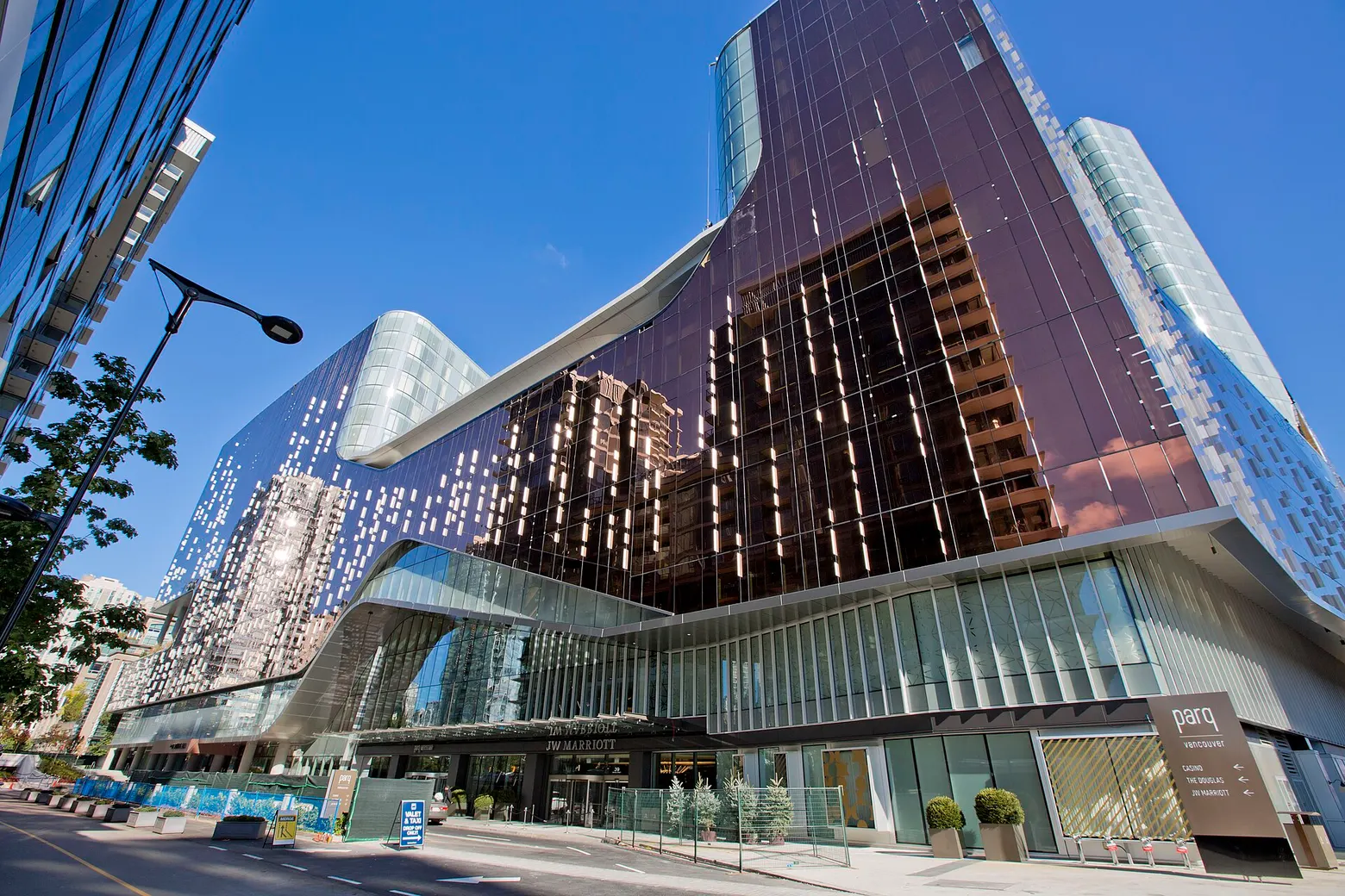 The copper-glass Parq Vancouver building on a sunny day